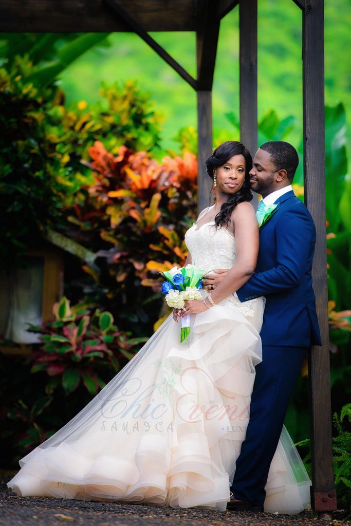 Happy couple with tropical flowers with big beautiful colorful leaves